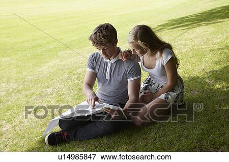 Boy and girl reading a map View Large Photo Image Stock Photo - Boy and girl reading a map. Fotosearch