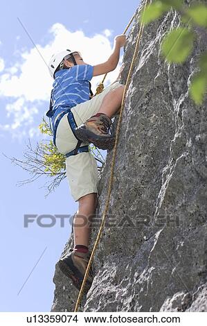 Boy climbing up a hill View Large Photo Image Picture - Boy climbing up a hill. Fotosearch