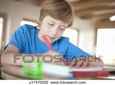 Stock Image - Boy doing his homework. Fotosearch