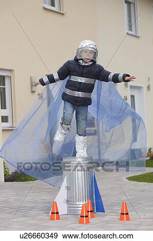 Boy dressed as spaceman, trying to fly View Large Photo Image Stock Photo - Boy dressed as spaceman, trying to fly. Fotosearch