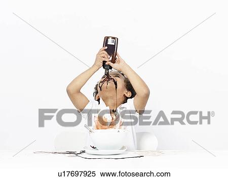 Boy eating chocolate sauce View Large Photo Image Stock Photography - Boy eating chocolate sauce. Fotosearch