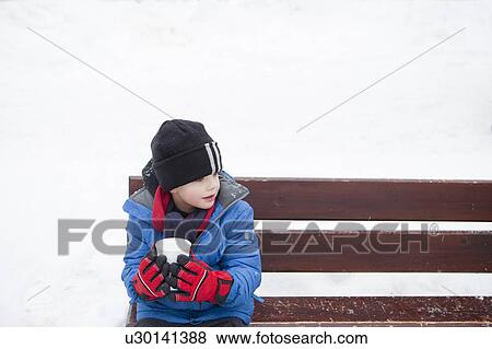 Boy enjoying a hot drink on a cold day View Large Photo Image Stock Photo - Boy enjoying a hot drink on a cold day. Fotosearch