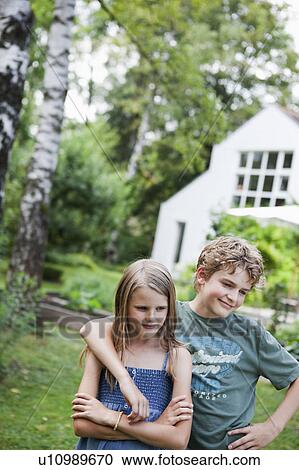 Stock Image - Boy hugging girl in the garden. Fotosearch