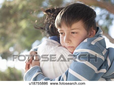 Stock Photograph - Boy hugging Mother. Fotosearch