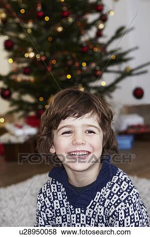 Stock Photo - Boy in front of xmas tree. Fotosearch