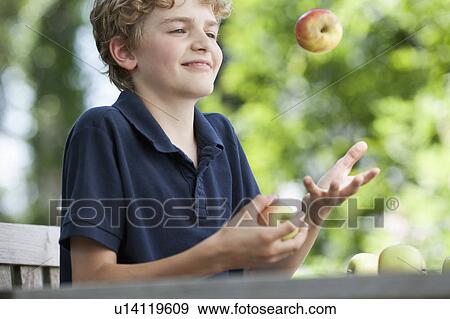 Stock Photo - Boy juggling apples. Fotosearch
