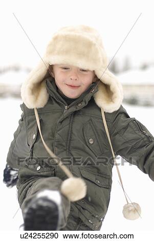 Stock Image - Boy kicking snow. Fotosearch