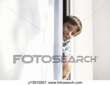 Boy looking out of window View Large Photo Image Stock Photo - Boy looking out of window. Fotosearch