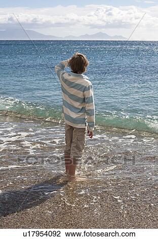 Boy looking out to sea View Large Photo Image Stock Image - Boy looking out to sea. Fotosearch