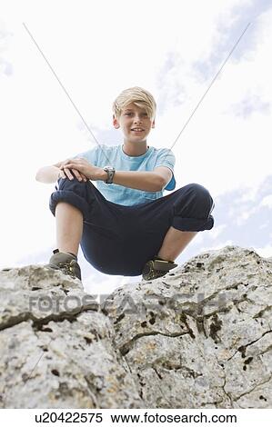 Stock Photography - Boy on a rock. Fotosearch