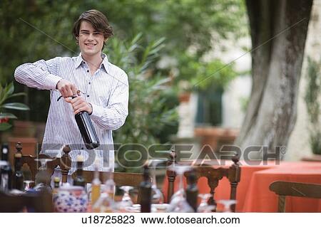 Boy opening wine View Large Photo Image Stock Image - Boy opening wine. Fotosearch