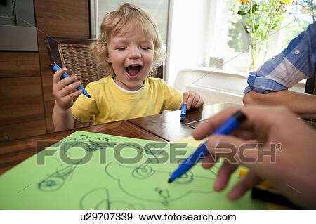 Boy painting on table View Large Photo Image Stock Photo - Boy painting on table. Fotosearch