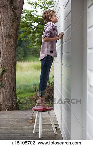 Boy peaking into window View Large Photo Image Stock Image - Boy peaking into window. Fotosearch