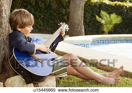 Boy playing guitar by pool View Large Photo Image Stock Photography - Boy playing guitar by pool. Fotosearch