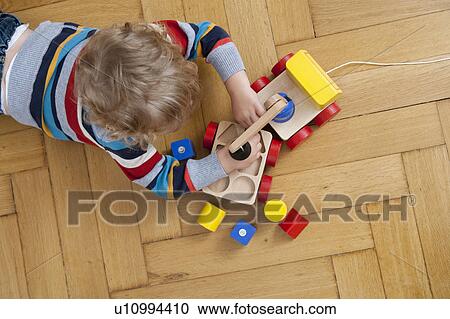 Boy playing on floor View Large Photo Image Stock Image - Boy playing on floor. Fotosearch