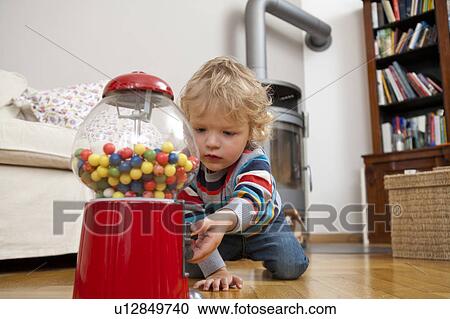 Stock Image - Boy playing on floor. Fotosearch