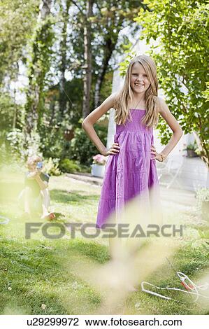 Stock Image - Boy shooting at girl with a pump-gun. Fotosearch