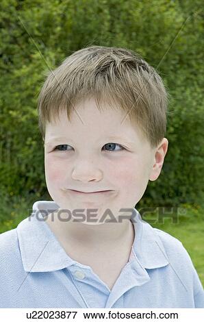 Stock Photo - Boy smiling in the garden. Fotosearch