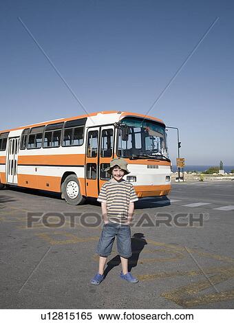 Boy standing near public bus View Large Photo Image Stock Photography - Boy standing near public bus. Fotosearch