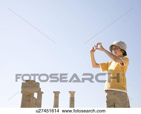 Boy taking photo at historical ruins View Large Photo Image Picture - Boy taking photo at historical ruins. Fotosearch