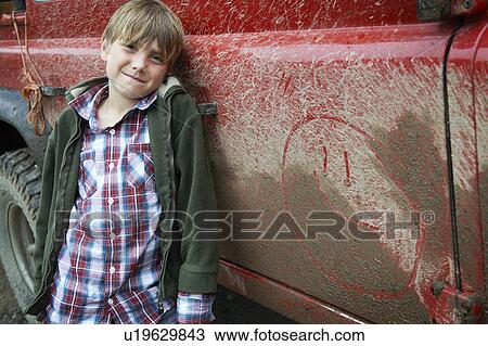 Stock Image - Boy with 4x4 landrover. Fotosearch