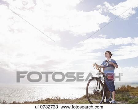 Stock Image - Boy with bicycle. Fotosearch