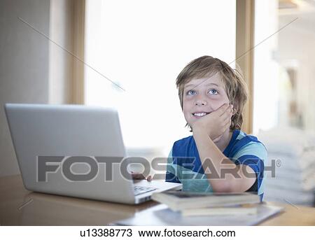 Boy with laptop, daydreaming View Large Photo Image Stock Image - Boy with laptop, daydreaming. Fotosearch