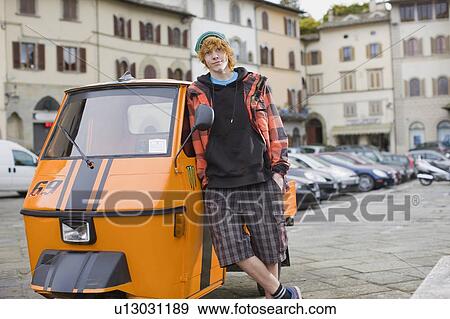 Stock Photo - Boy with Piaggio Ape. Fotosearch