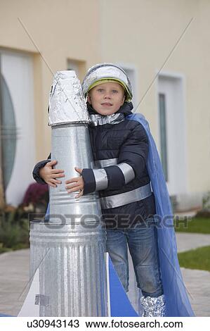 Stock Image - Boy with self constructed rocket. Fotosearch