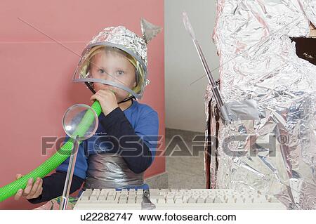 Boy with self constructed space house View Large Photo Image Stock Photo - Boy with self constructed space house. Fotosearch