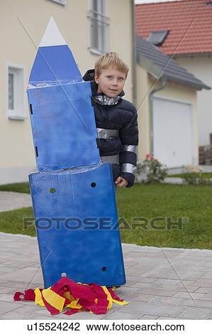 Stock Image - Boy with self made rocket. Fotosearch