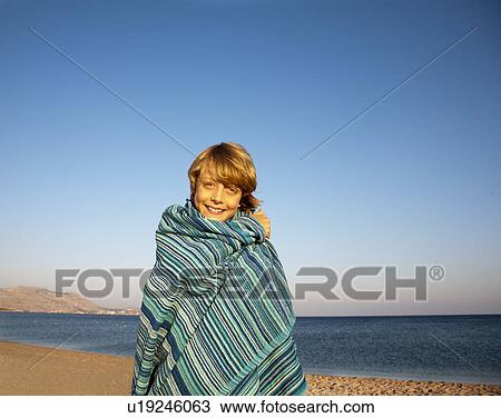Boy wrapped in towel by sea View Large Photo Image Stock Image - Boy wrapped in towel by sea. Fotosearch