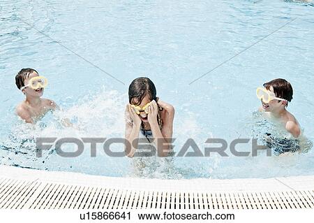 Boys splashing girl in swimmingpool View Large Photo Image Stock Image - Boys splashing girl in swimmingpool. Fotosearch