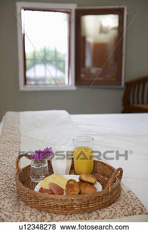 Stock Photo - Breakfast tray laid on hotel bed. Fotosearch