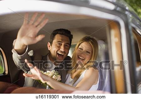 Stock Image - Bridal couple in car. Fotosearch