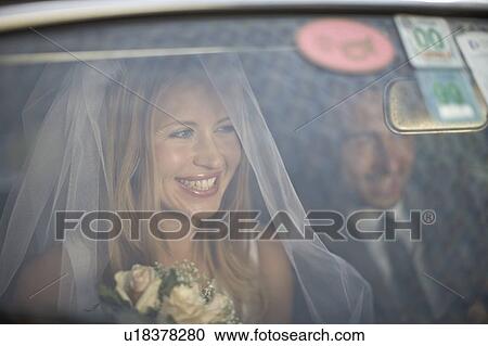 Stock Image - Bridal couple in car. Fotosearch