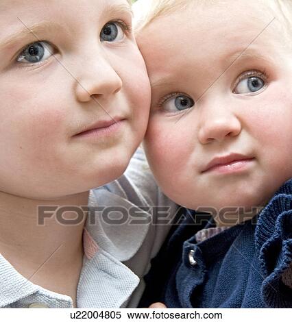 Stock Photography - Brother and his baby sister. Fotosearch