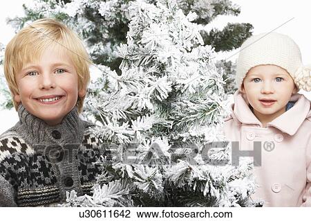 Brother and sister next to snowy trees View Large Photo Image Stock Image - Brother and sister next to snowy trees. Fotosearch