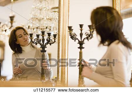 Stock Photo - Browsing in antique shop. Fotosearch