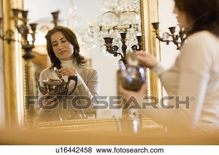 Stock Photo - Browsing in antique shop. Fotosearch