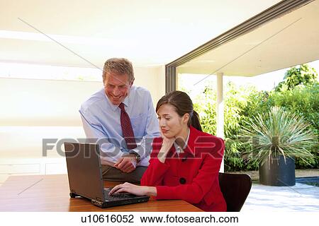 Business couple look at computer View Large Photo Image Stock Image - Business couple look at computer. Fotosearch