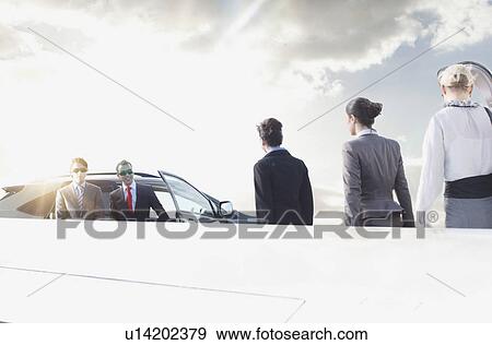 Stock Photo - Business executives on the move. Fotosearch