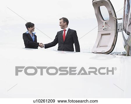 Stock Photo - Business Executives shaking hands. Fotosearch