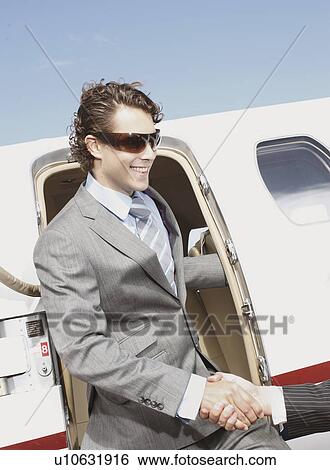 Stock Photograph - Business executives shaking hands. Fotosearch