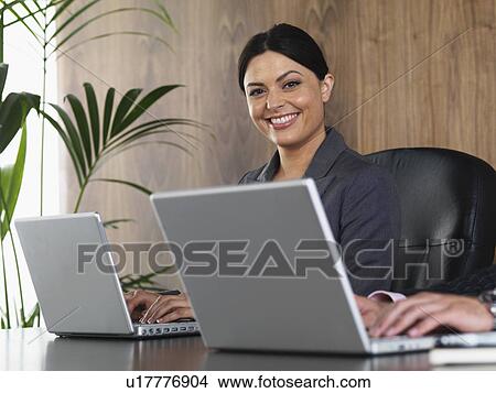 Business man and woman at desk View Large Photo Image Picture - Business man and woman at desk. Fotosearch