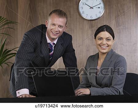 Business man and woman at desk View Large Photo Image Picture - Business man and woman at desk. Fotosearch