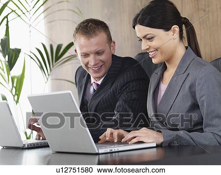 Business man and woman at desk View Large Photo Image Stock Image - Business man and woman at desk. Fotosearch
