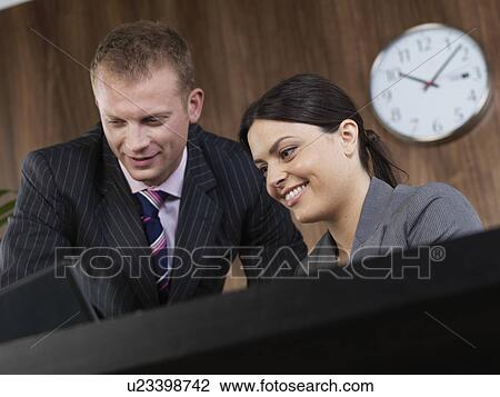 Business man and woman at desk View Large Photo Image Stock Image - Business man and woman at desk. Fotosearch