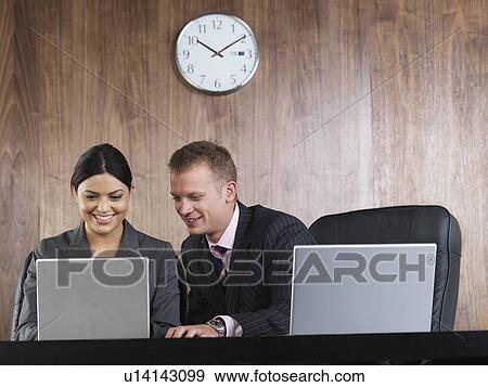 Business man and woman at desk View Large Photo Image Stock Photo - Business man and woman at desk. Fotosearch