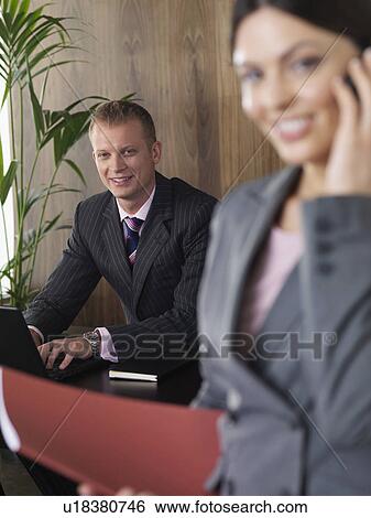 Stock Photograph - Business man and woman in office. Fotosearch